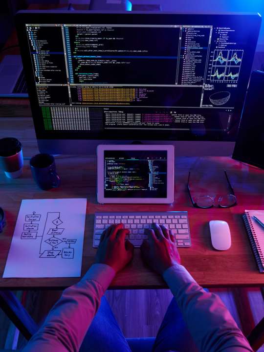top-view-of-unrecognizable-hacker-performing-cyberattack-at-night-1